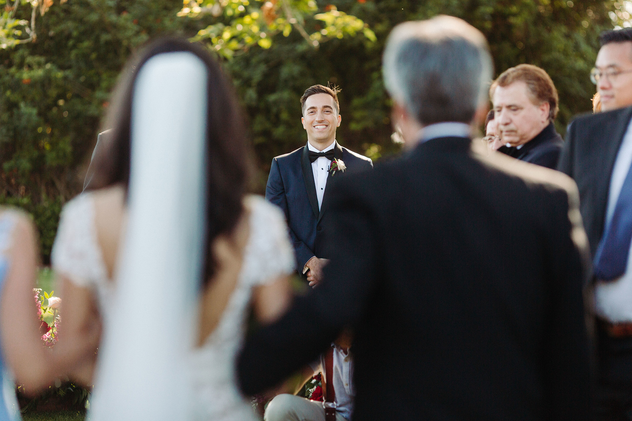 grooms sees bride walk down aisle