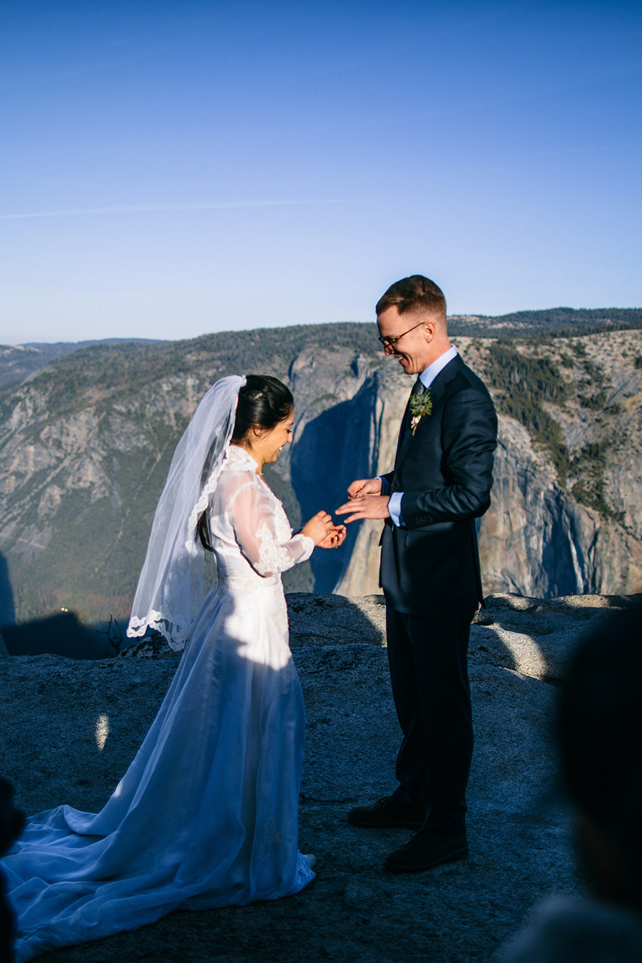 bride and groom exchanging rings at Taft point Yosemite elpoement