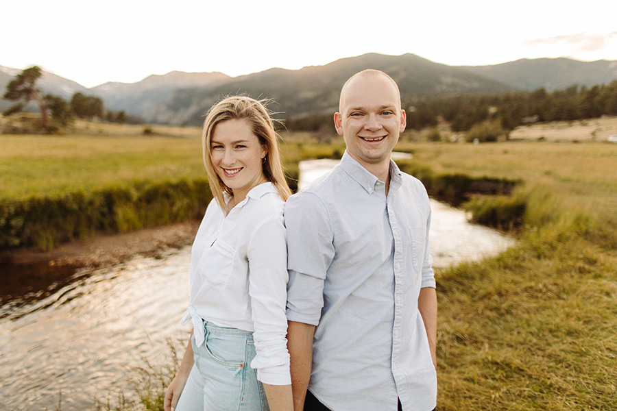 couple standing by a creek during their mountain engagement shoot